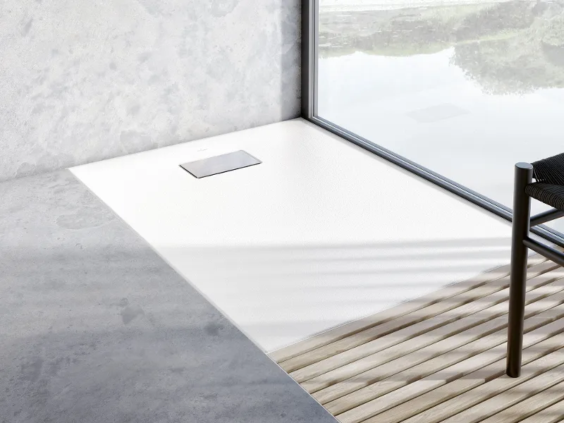 A close-up of a white rimless Le Valence shower tray in a modern bathroom by Villeroy & Boch with wood panelling.