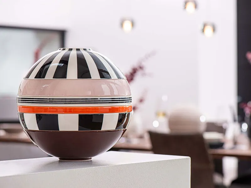 A Villeroy & Boch striped La Boule Memphis on a table in a dining room.