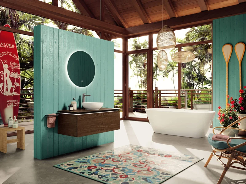 More to See mirror in a Hawaiian-style bathroom Luxurious bathroom with a large More to See mirror and a white Loop & Friends washbasin in front of a turquoise-coloured wall, surrounded by lush greenery visible through the full-length windows