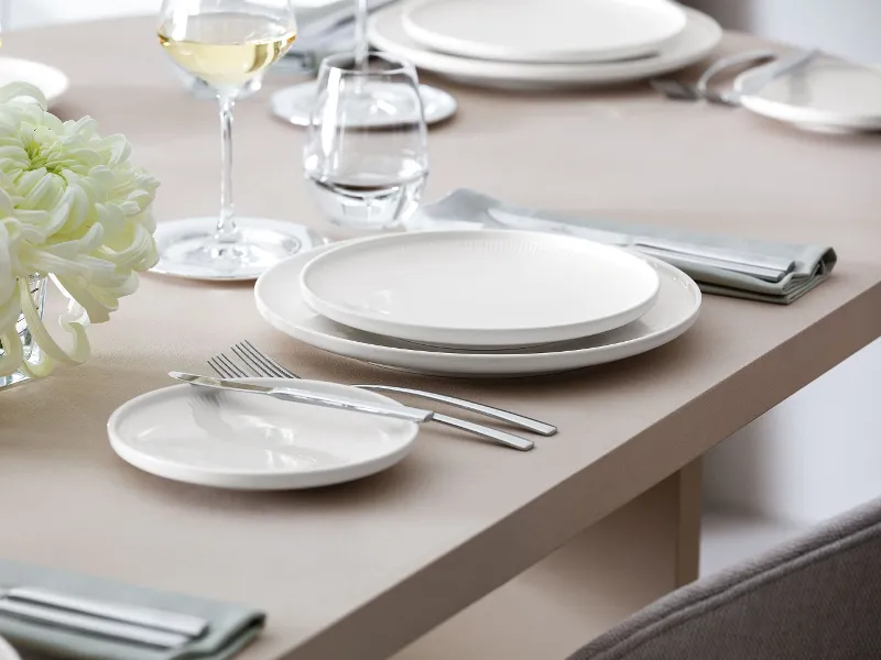 A table set with Afina plates shown in a side view to see the floating effect of the plates.