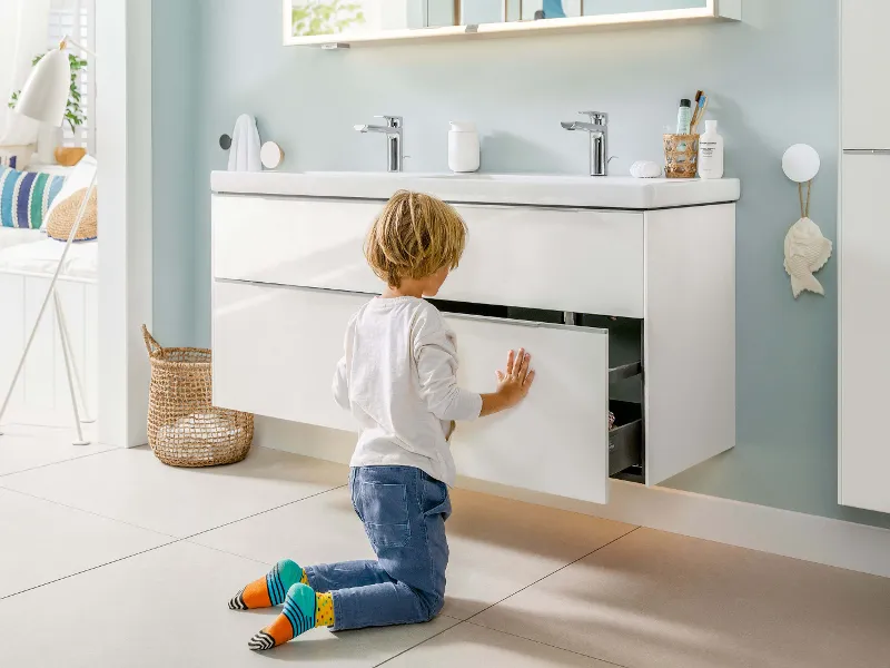 A boy opening a drawer on a white Subway 3.0 vanity unit.