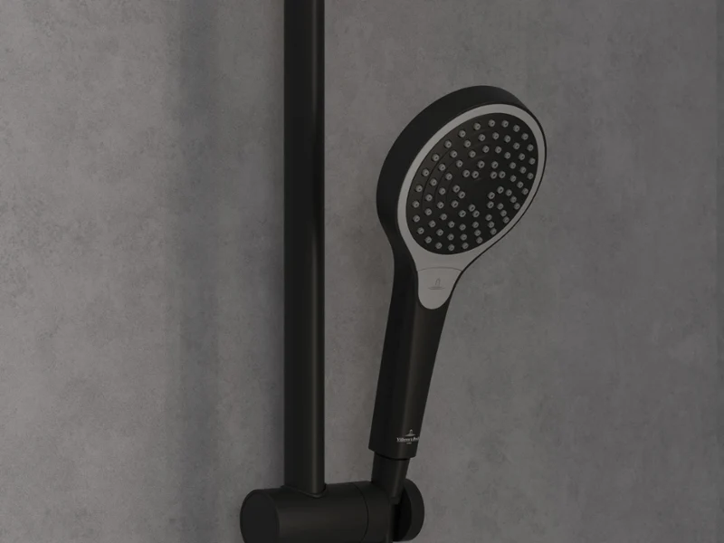 Verve Shower shower tap in luxurious gold A modern shower with a gold-coloured rain shower head and a hand shower, mounted on a grey tiled wall, next to a shelf with toiletries and a sponge.