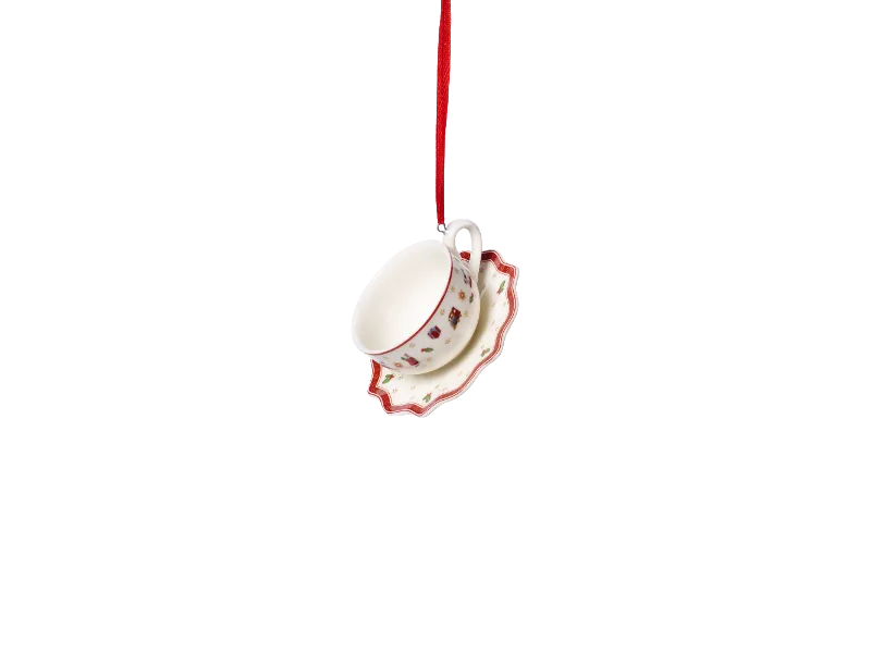 Advent Calendar sneak peak - 07 Teacup and saucer ornament A teacup and saucer with a Christmas pattern hang from a red ribbon.