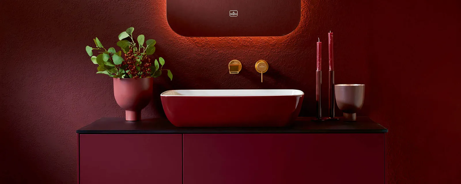 A bathroom with red walls and an Artis washbasin by Villeroy & Boch.