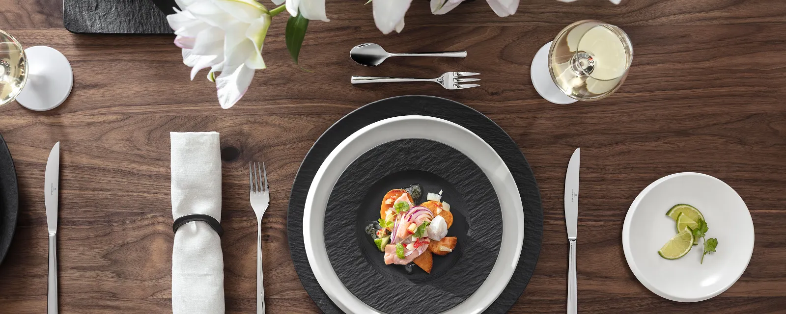 Black crockery and glasses on a table. Elegant table decoration with black crockery and stylish glasses – for an exceptional Classy Dining experience.