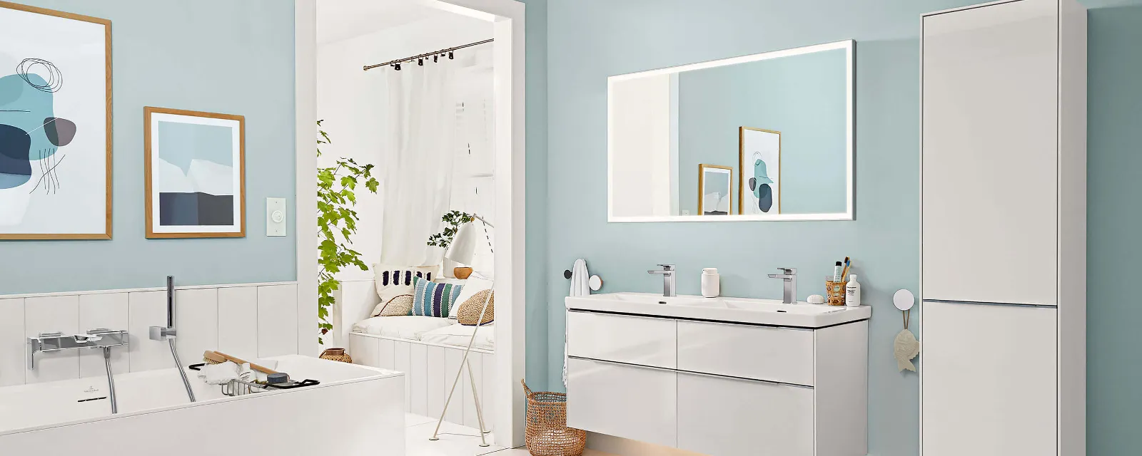 A white bathroom with blue walls and a flat illuminated Subway 3.0 mirror and coordinating bathroom furniture.