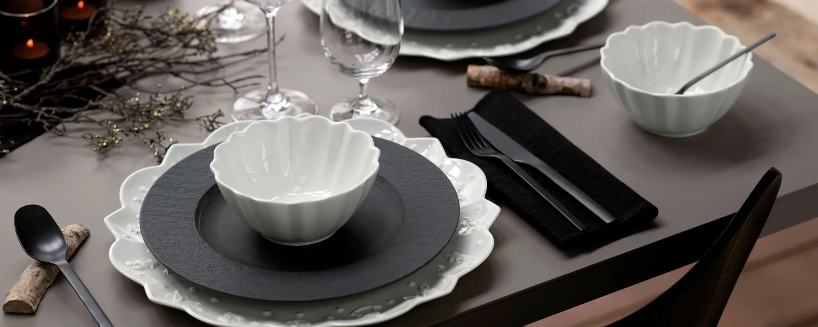 A table set with Villeroy & Boch black Manufacture plates and white Toy’s Delight tableware.