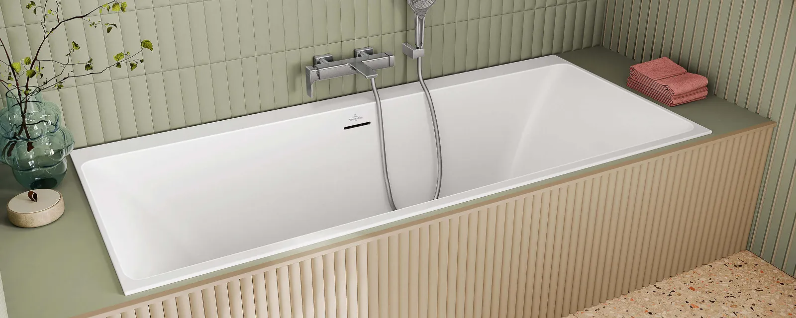 A white Subway 3.0 bath in a bathroom with green walls.