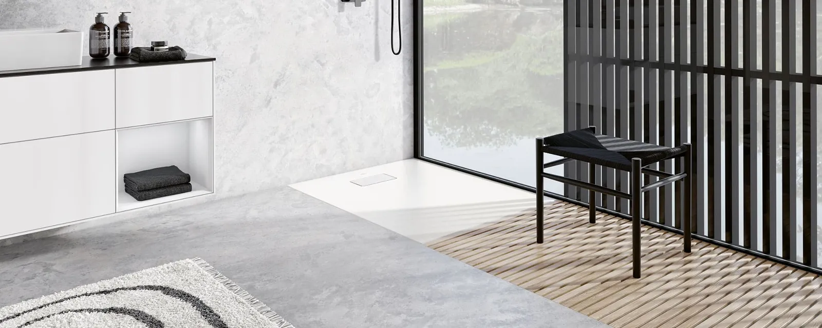 A white rimless Le Valence shower tray in a modern bathroom by Villeroy & Boch with wood panelling.