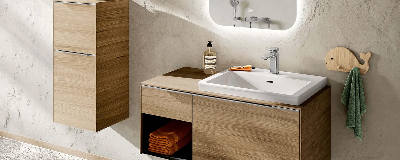 A white Subway 3.0 washbasin with brown furniture and tap.