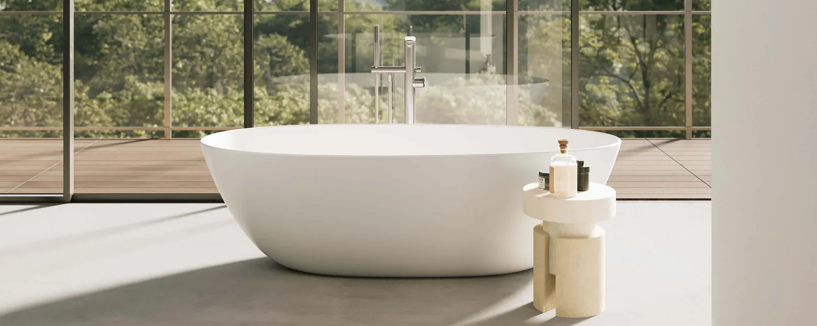 A white Antao bath in a room with a glass wall and trees.