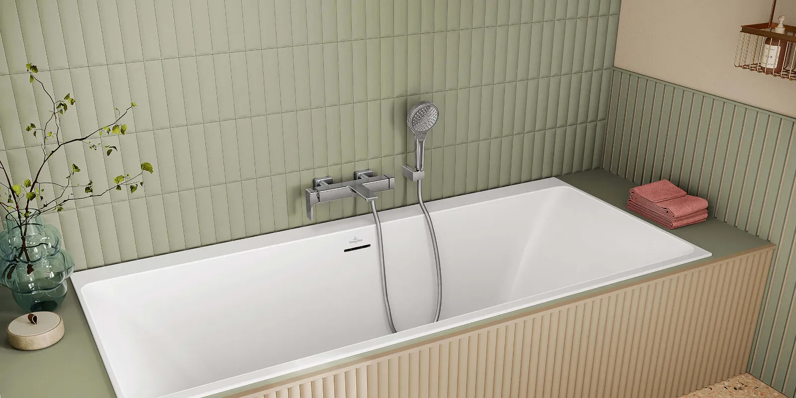 A Subway 3.0 bath tap on a bath with a hand shower in front of a green tiled wall