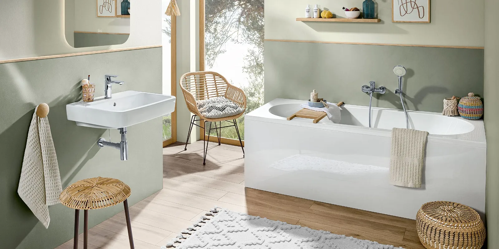 A bathroom with green walls, wooden furniture and a white O.novo bath and washbasin.