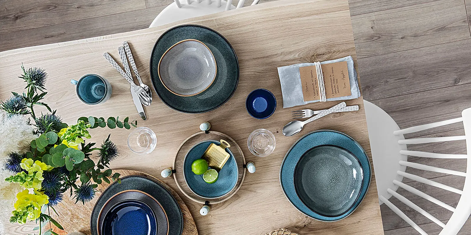 A wooden table with Villeroy & Boch Lave plates on top.