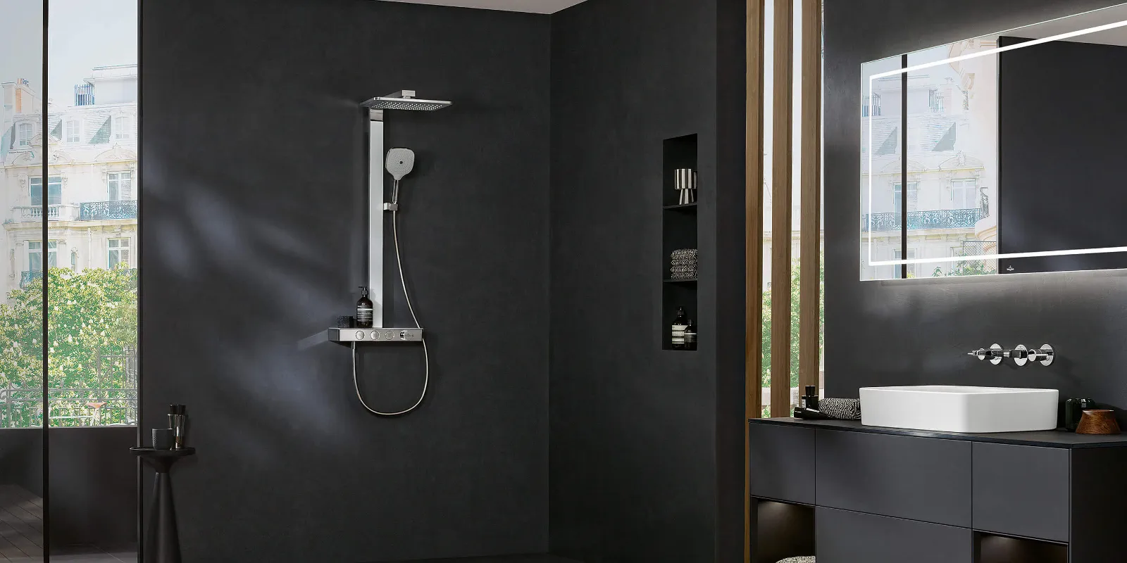 An Infinity Showers shower tap in a bathroom with black walls and a wooden floor.