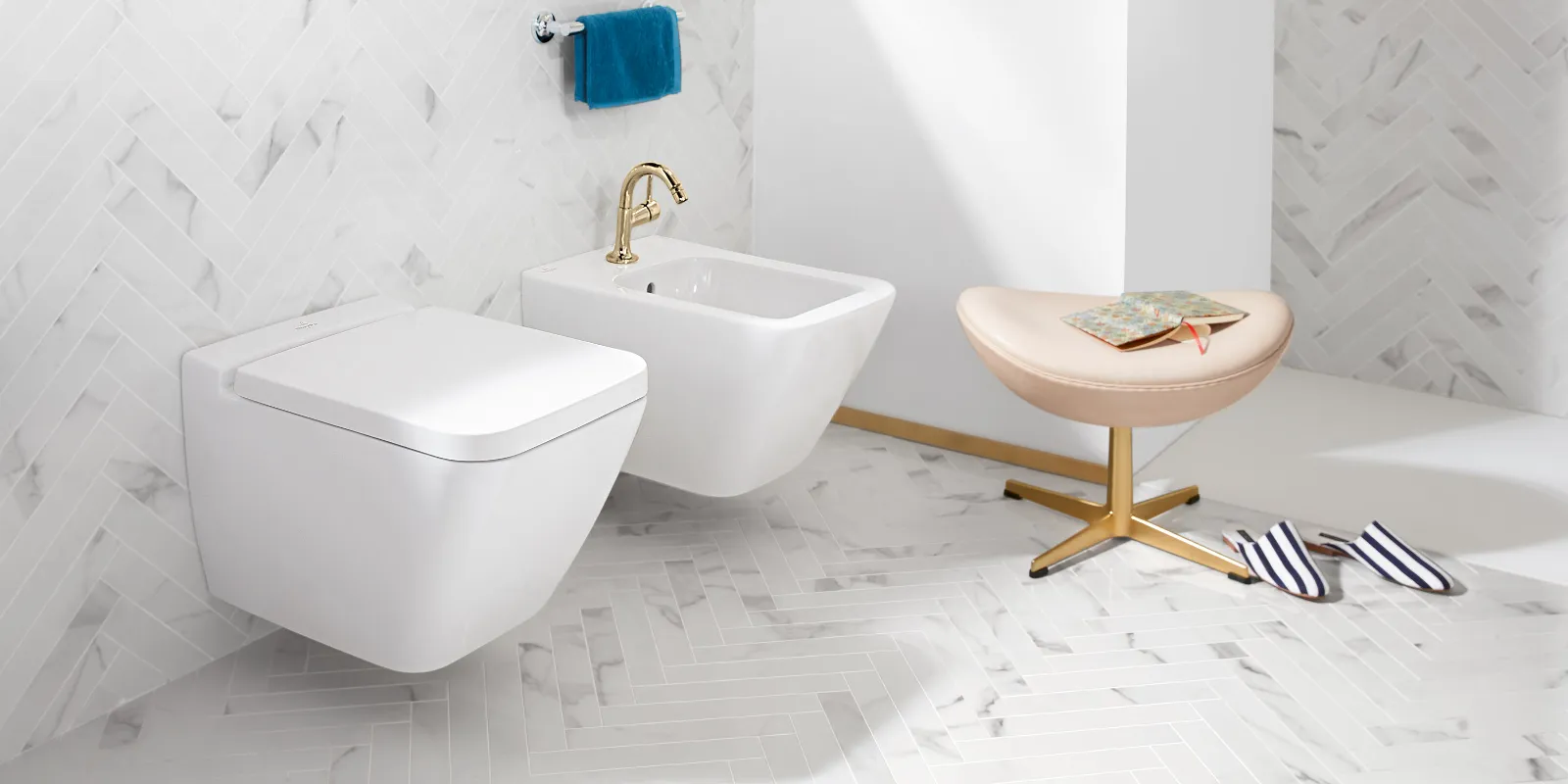 Finion toilet and bidet in white by Villeroy & Boch with stool and slippers.