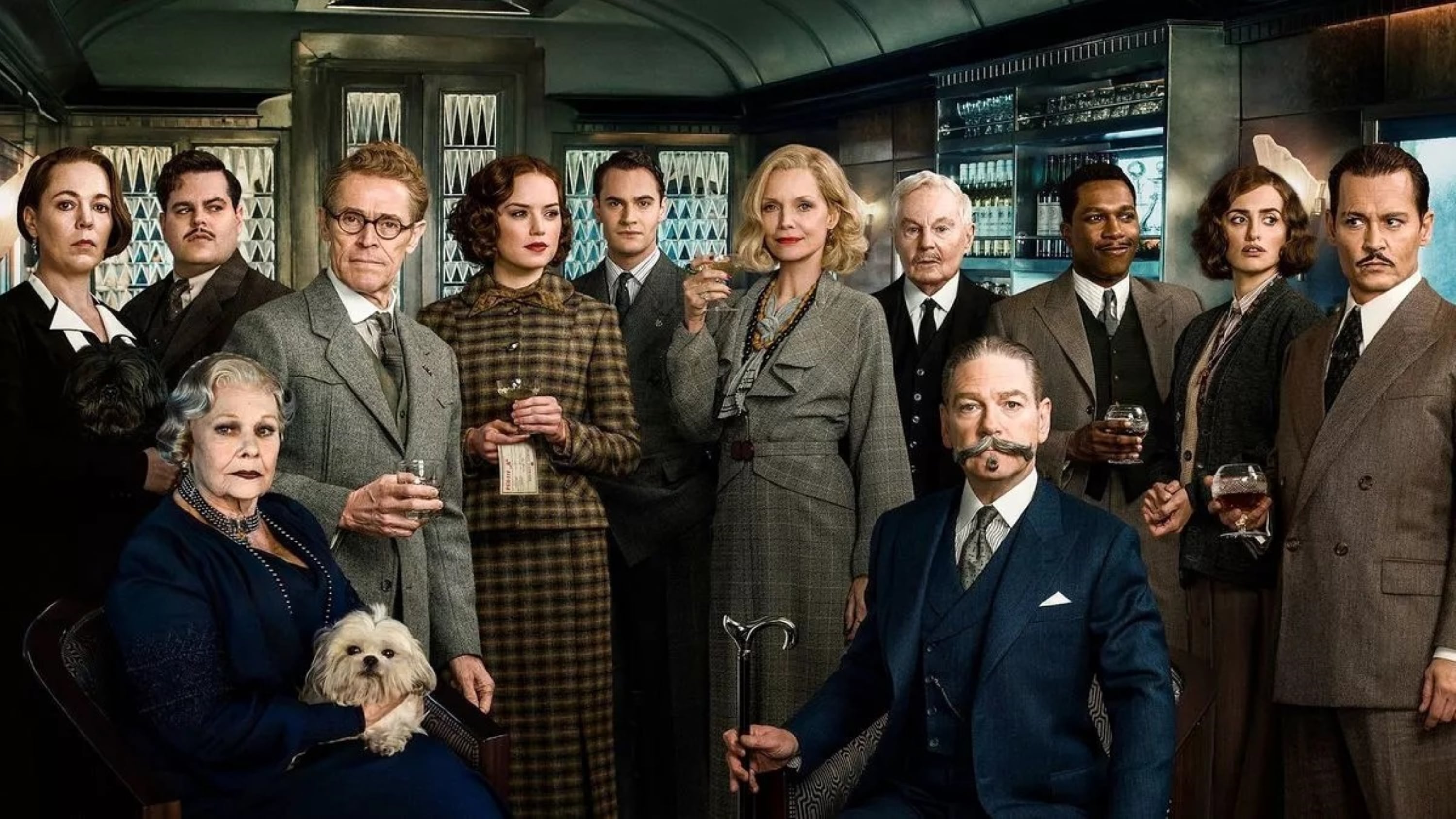 vb-orient-express A group of well-dressed actors in a train car hold drinks in Villeroy & Boch drinking glasses; a woman holds a small white dog.
