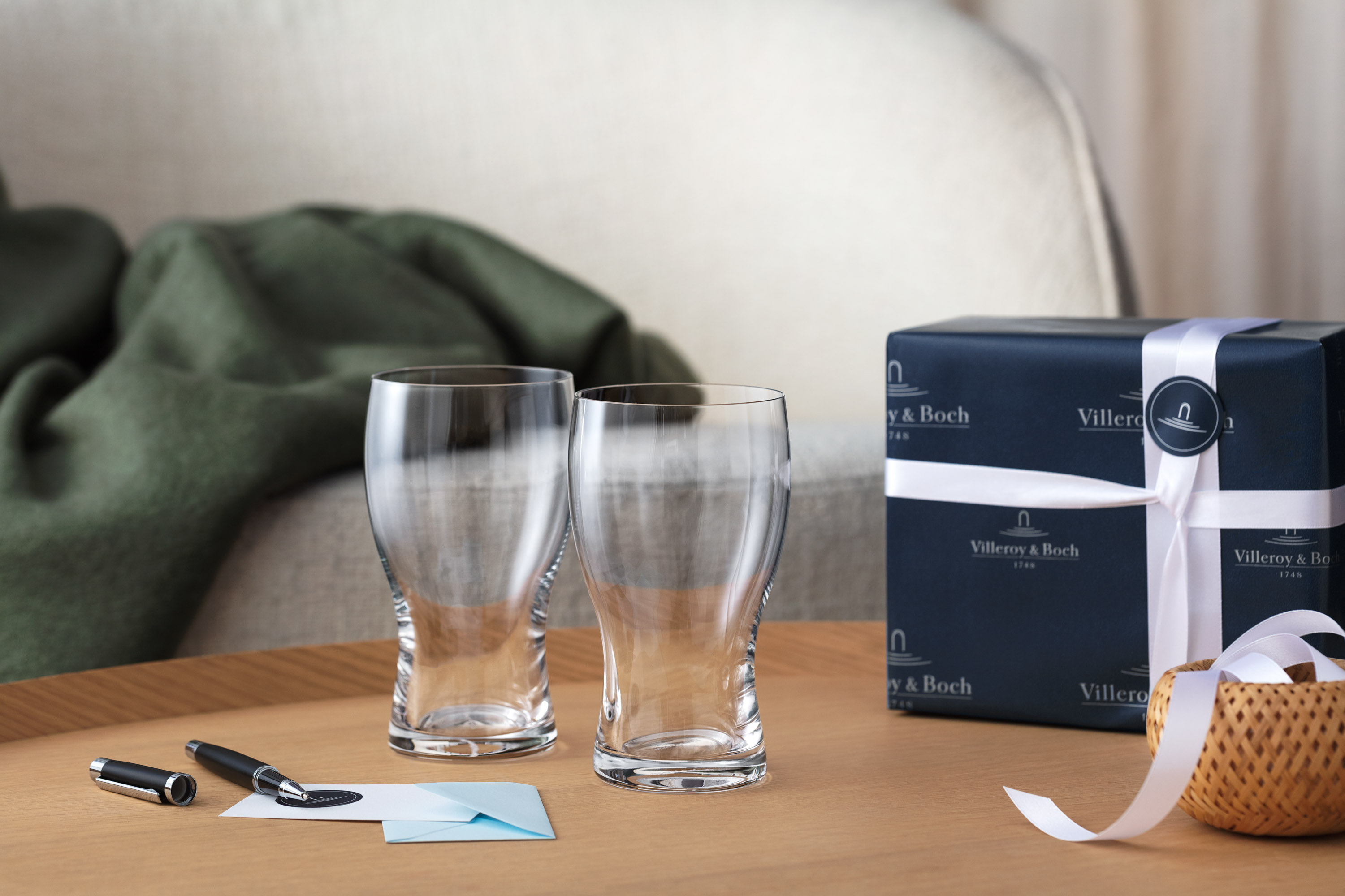 Purismo beer glasses with gift packaging Two Purismo beer glasses from Villeroy & Boch as a gift with card and fountain pen and gift box in the background