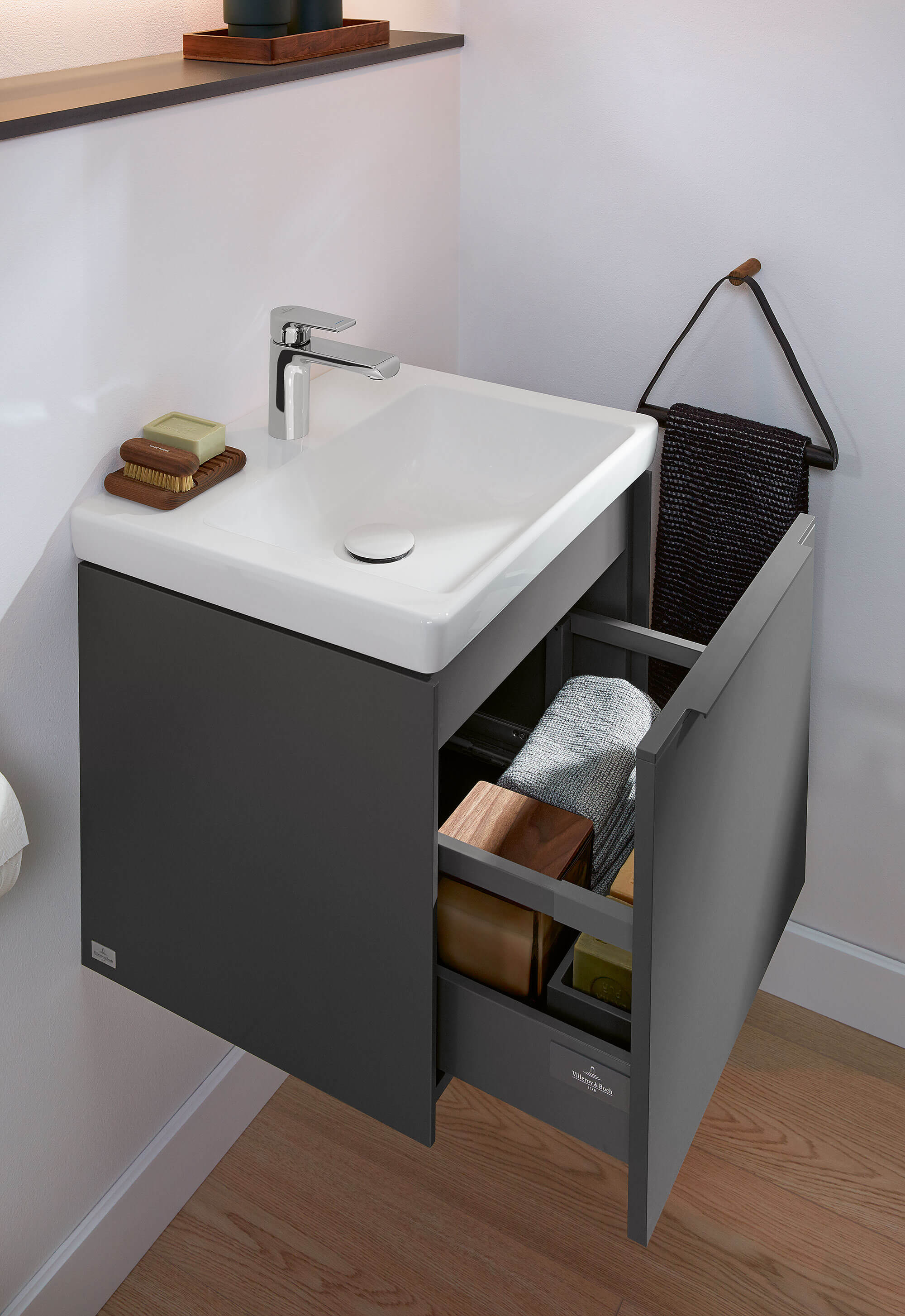 A white Subway 3.0 handwashbasin on a grey open vanity unit in a small modern bathroom.