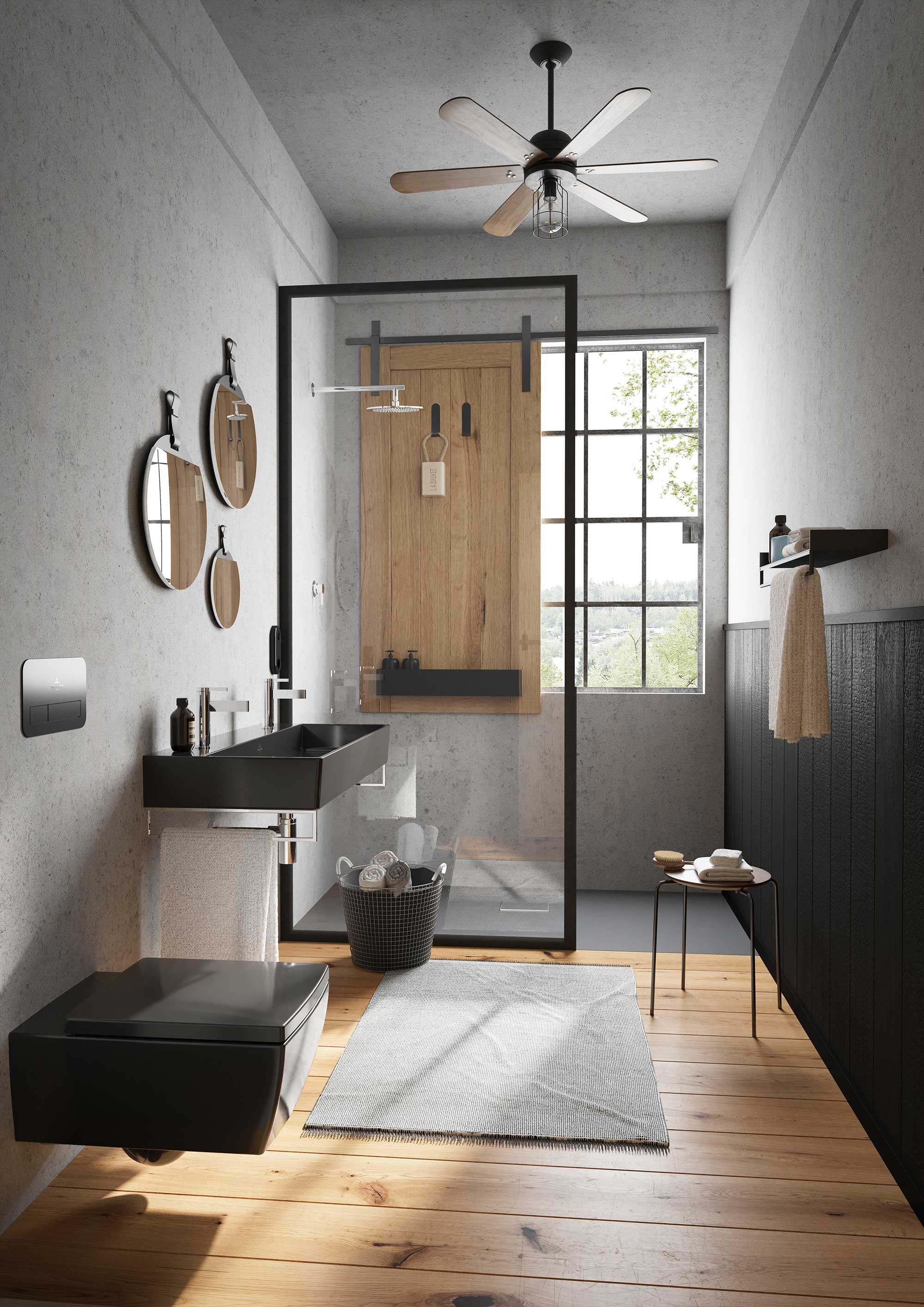Une salle de bains moderne avec un receveur de douche Squaro Infinity ainsi que des toilettes et un lavabo Memento 2.0 Une salle de bains moderne avec une douche vitrée, des robinetteries noires, des miroirs ronds, un receveur de douche Squaro Infinity Villeroy & Boch et des toilettes et un lavabo Memento 2.0, un petit tapis, une corbeille et une serviette sur un support.